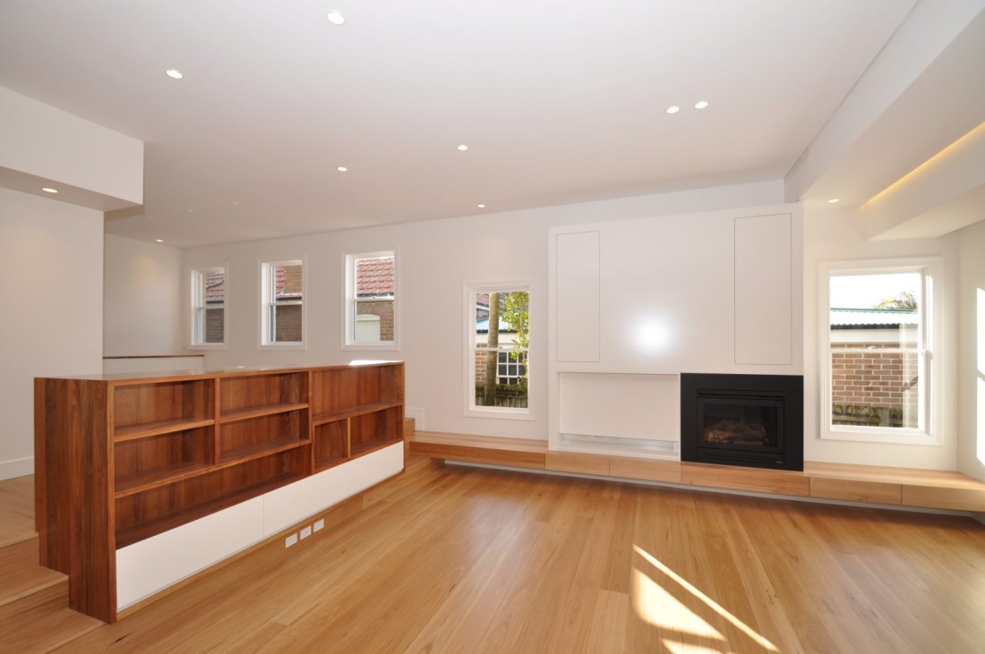 Mosman Living Room Fire Place with timber floorboards and timber shelving unit